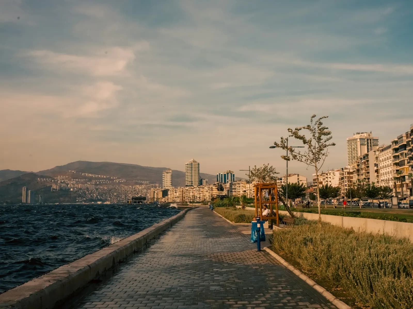 İzmir kordon boyunda deniz kenarı yürüyüş yolu ve şehir binaları